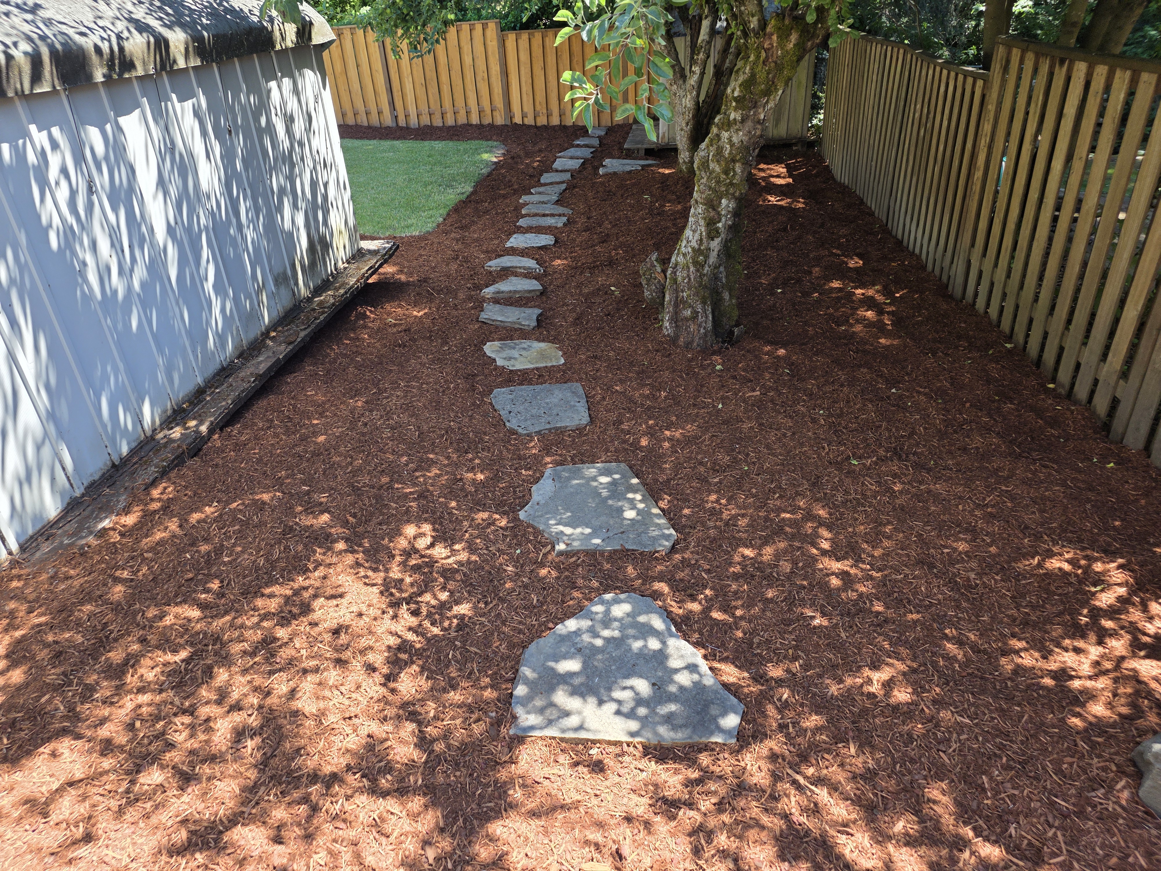Stone path through mulch garden landscaping
